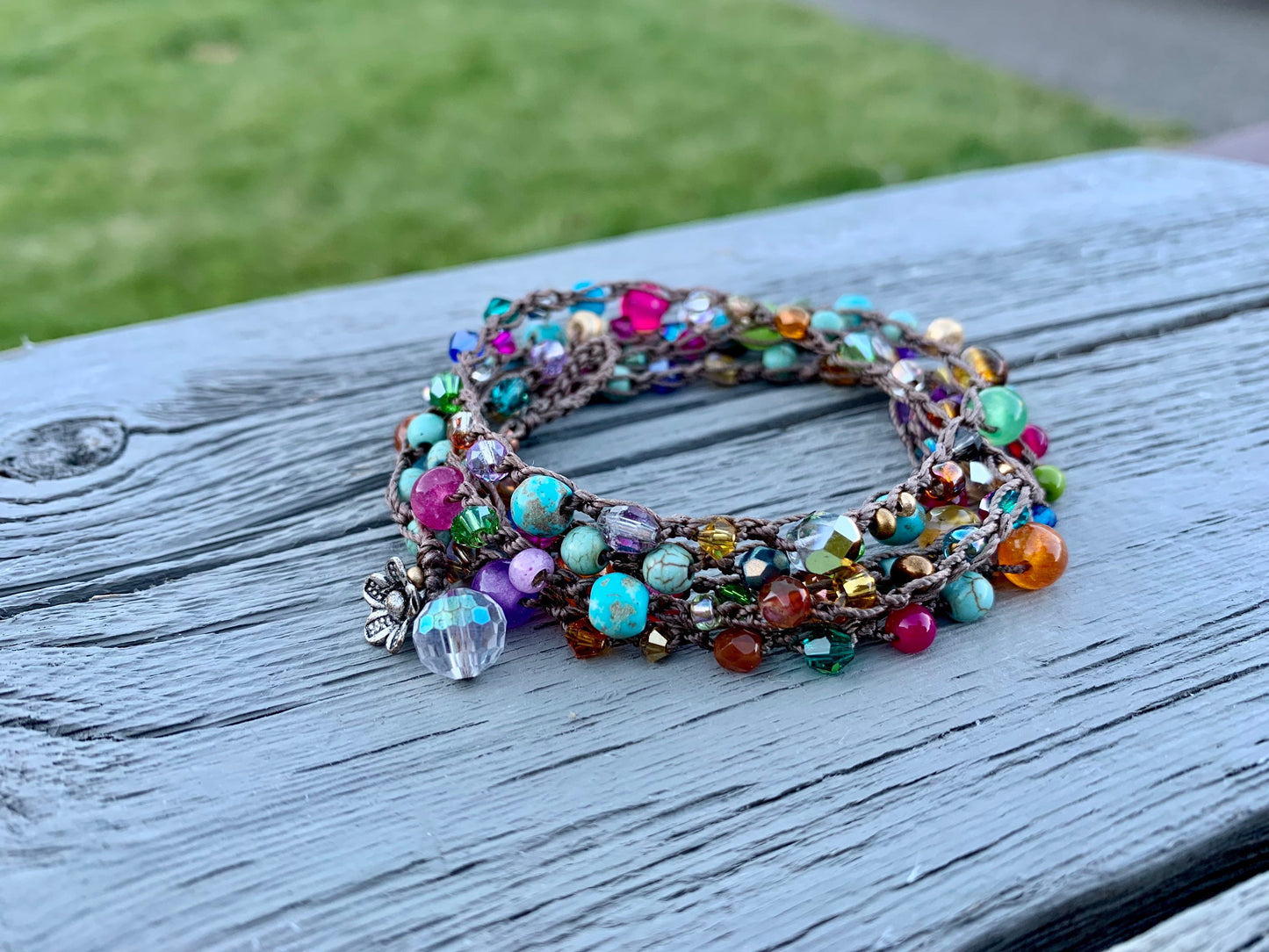 Colorful boho crocheted wrap, with bright turquoise, hot pink, orange gold..