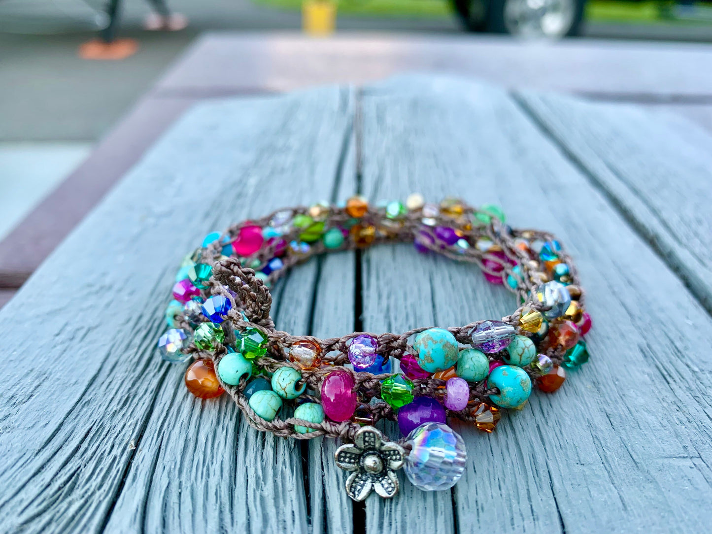 Colorful boho crocheted wrap, with bright turquoise, hot pink, orange gold..