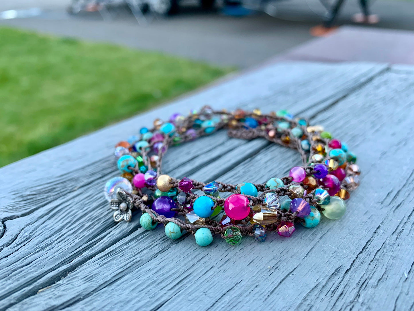 Colorful boho crocheted wrap, with bright turquoise, hot pink, orange gold..