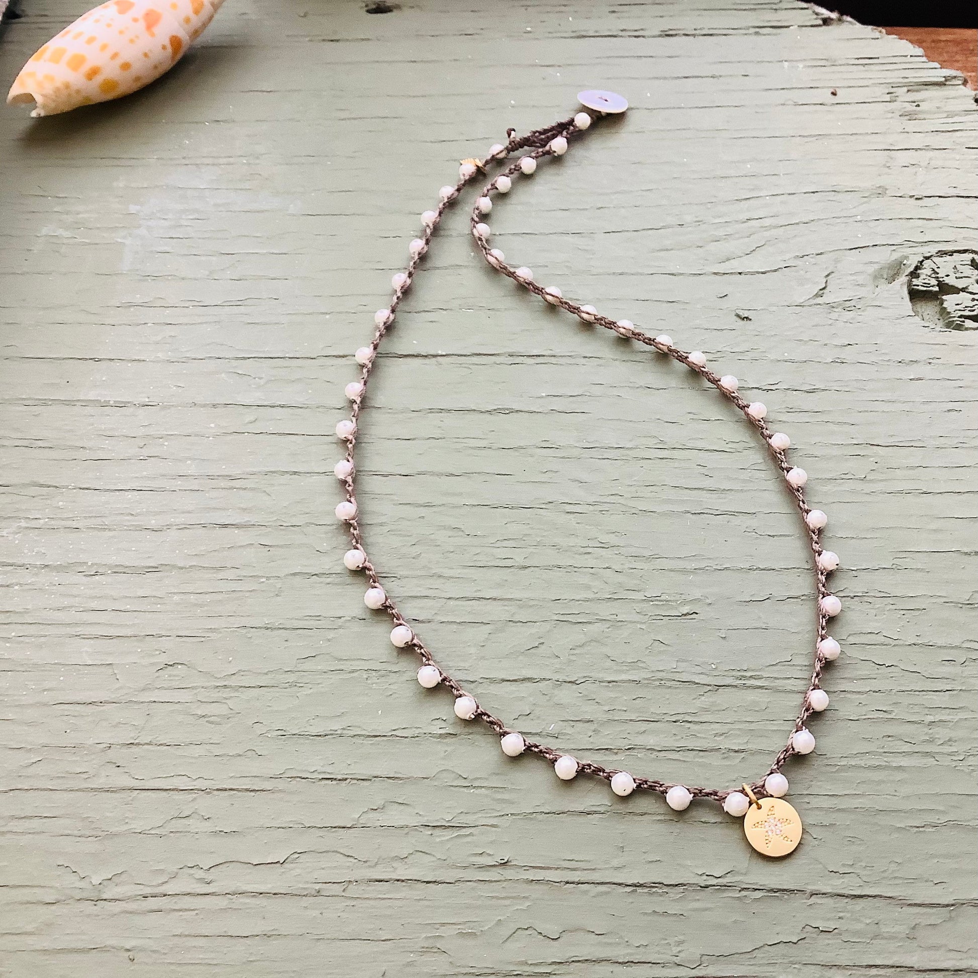 White mother of pearl crocheted necklace with silver starfish pendant